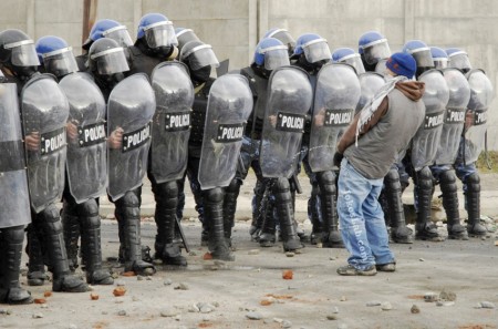 funny-protester-peeing-on-riot-police
